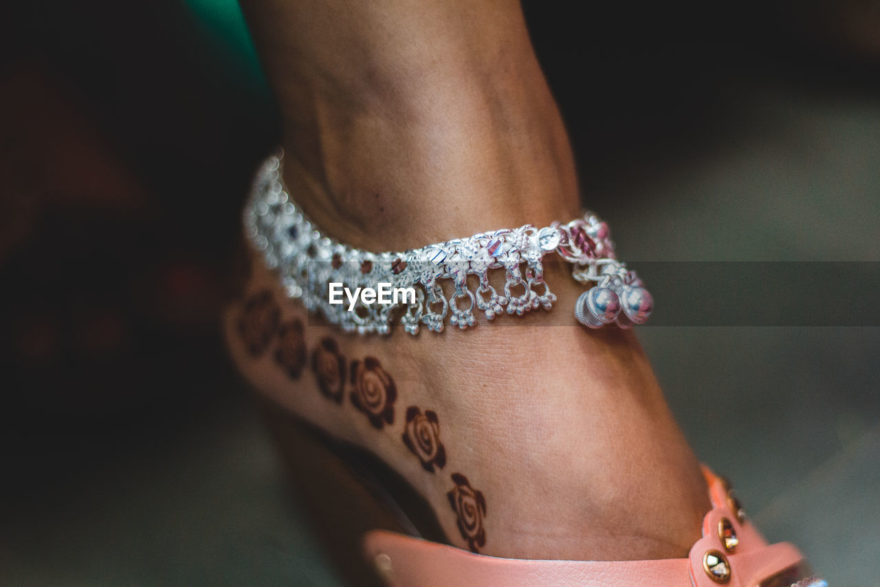 Low section of bride wearing anklet