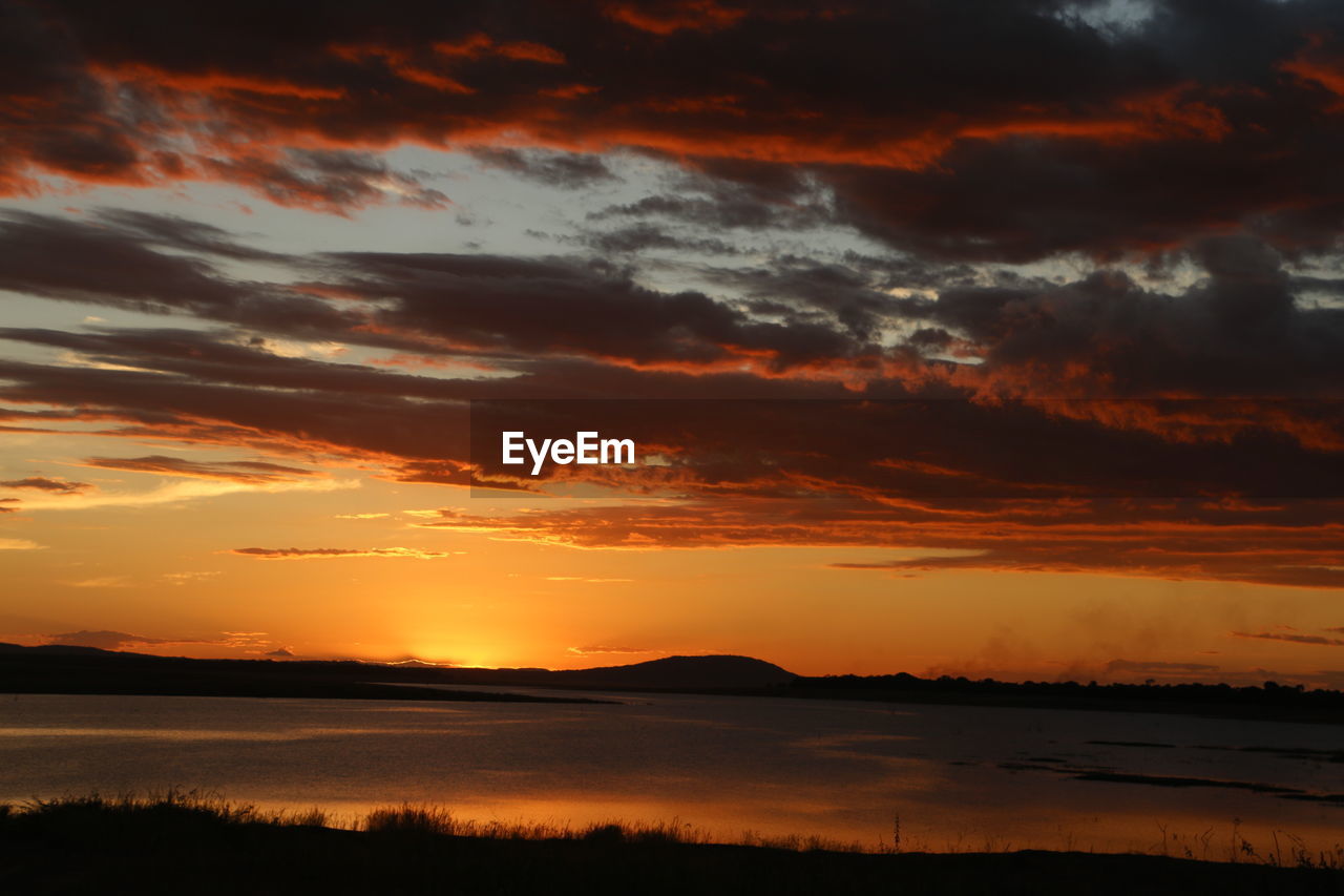 Scenic view of lake at sunset