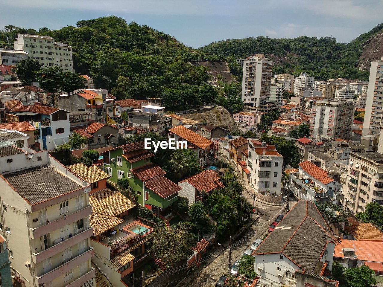 High angle view of houses in city against sky