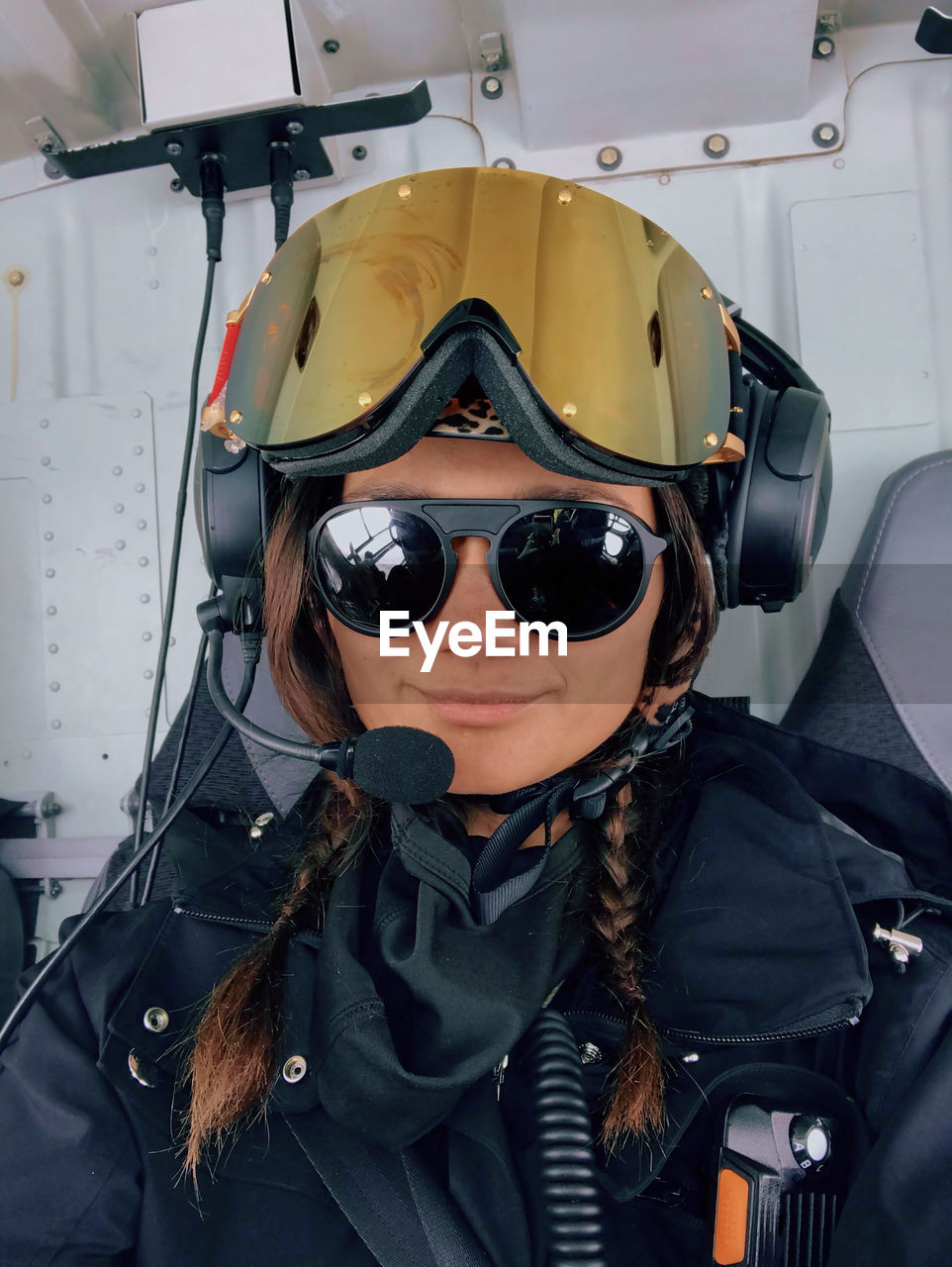 A confident woman smiles while heliskiing in the mountains of chile.