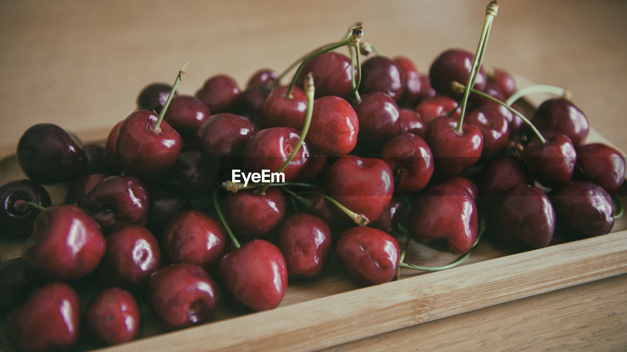 Cherry fruit on a wooden tray . high quality photo