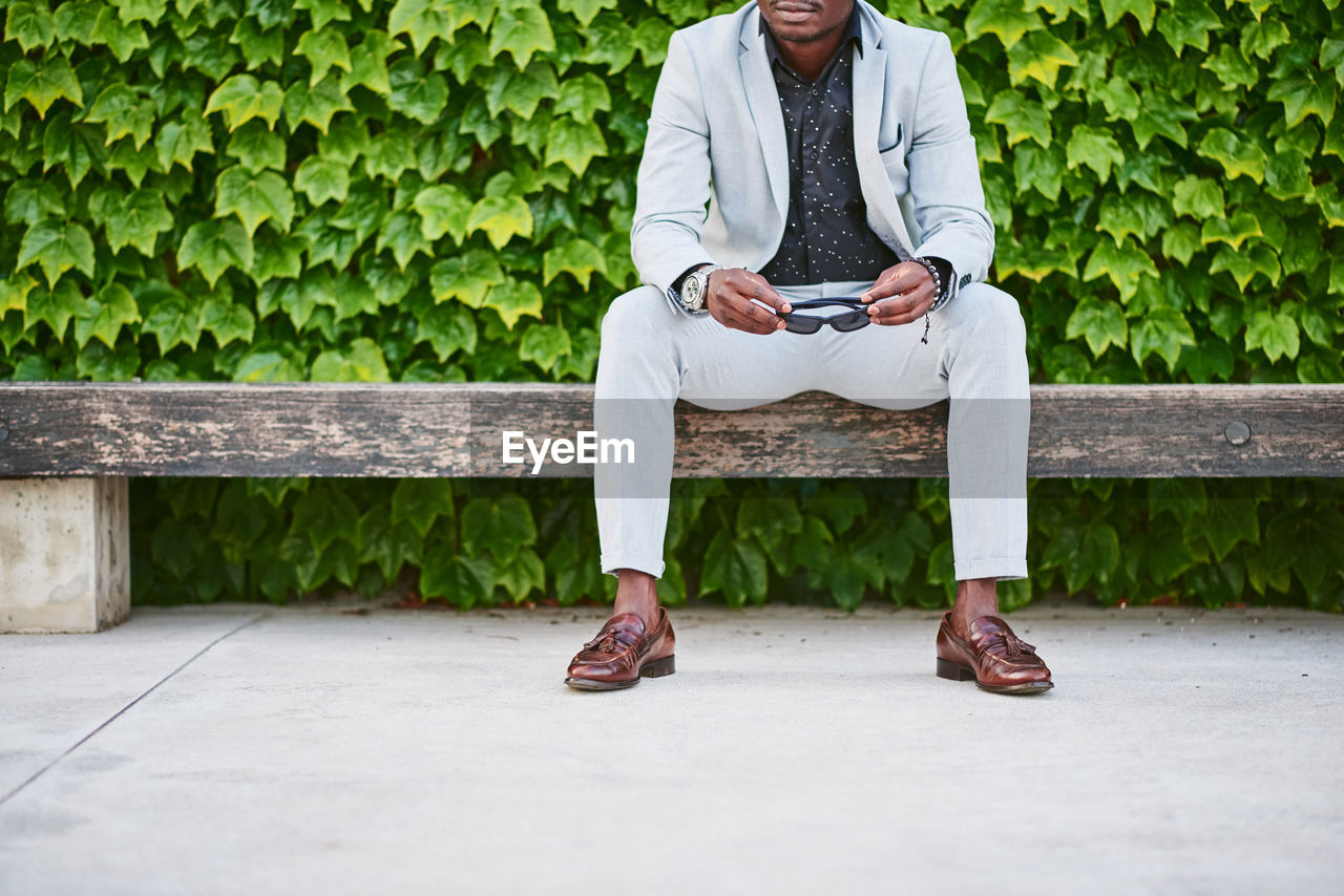 African american man sitting on a park bench