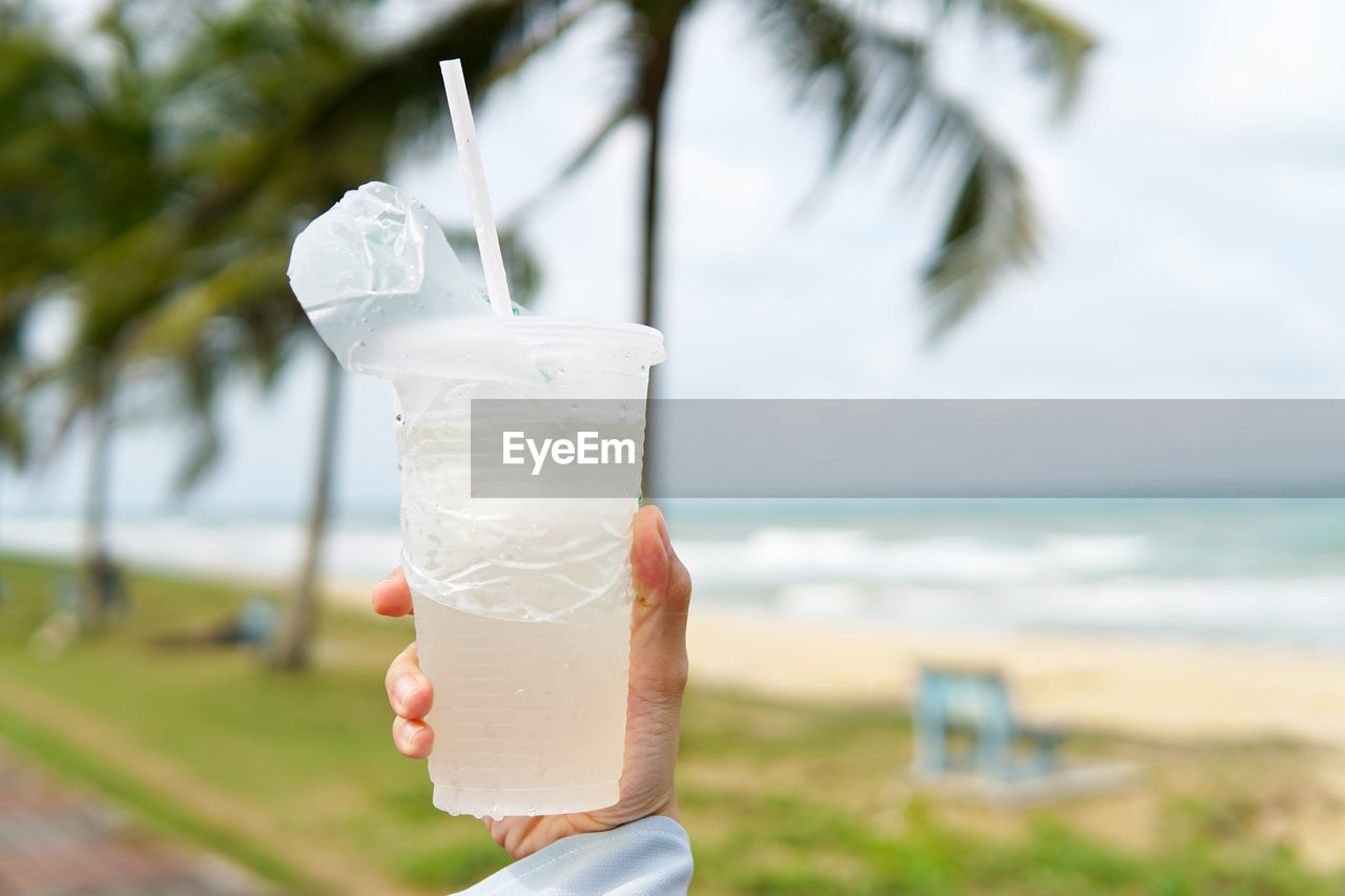 PERSON HOLDING GLASS OF WATER