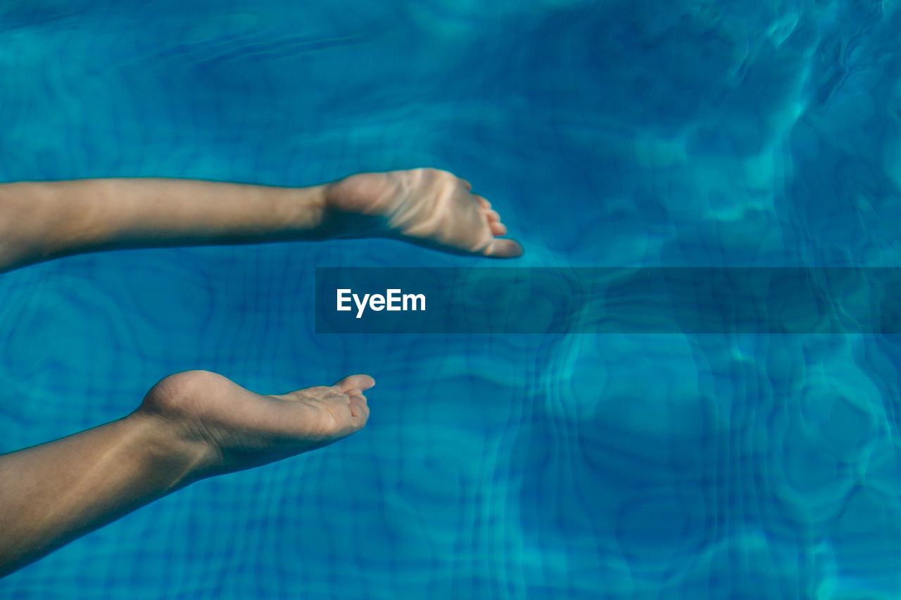 Low section of woman in swimming pool