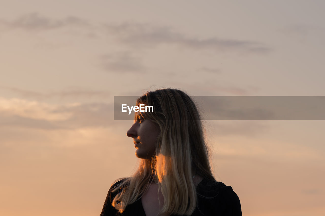 Portrait of a woman in the evening sun. profile portrait of a caucasian female backlit by the sunset