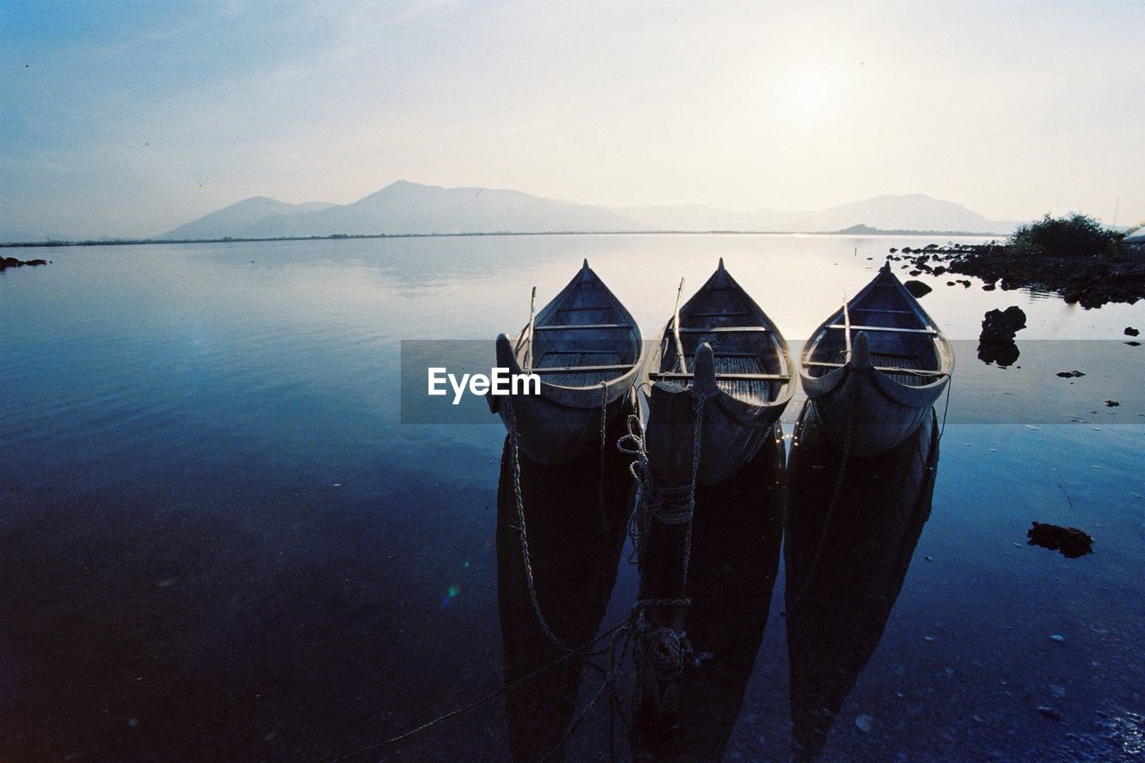 Calm lake with mountain range in background