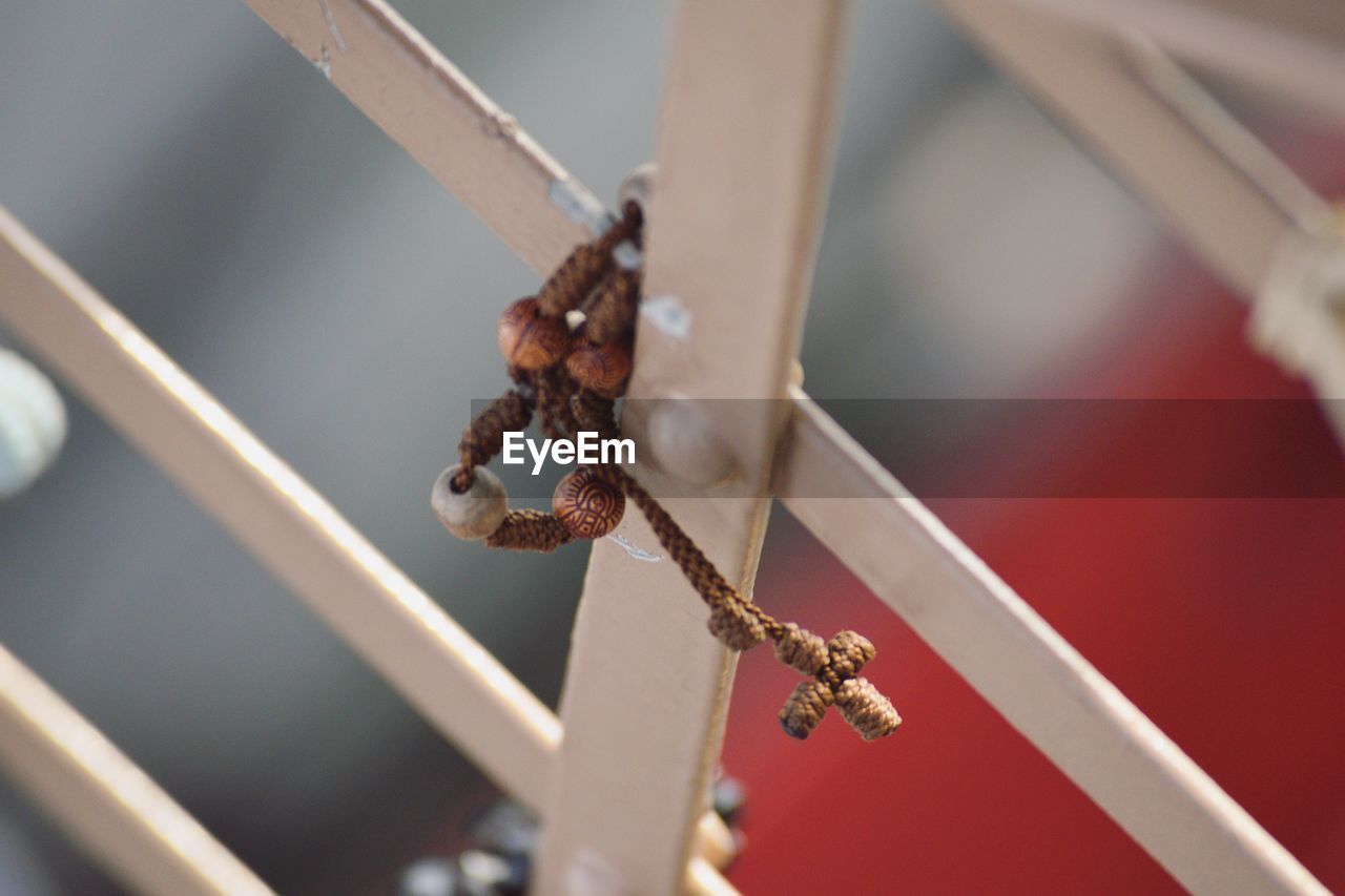 High angle view of cross necklace on metal