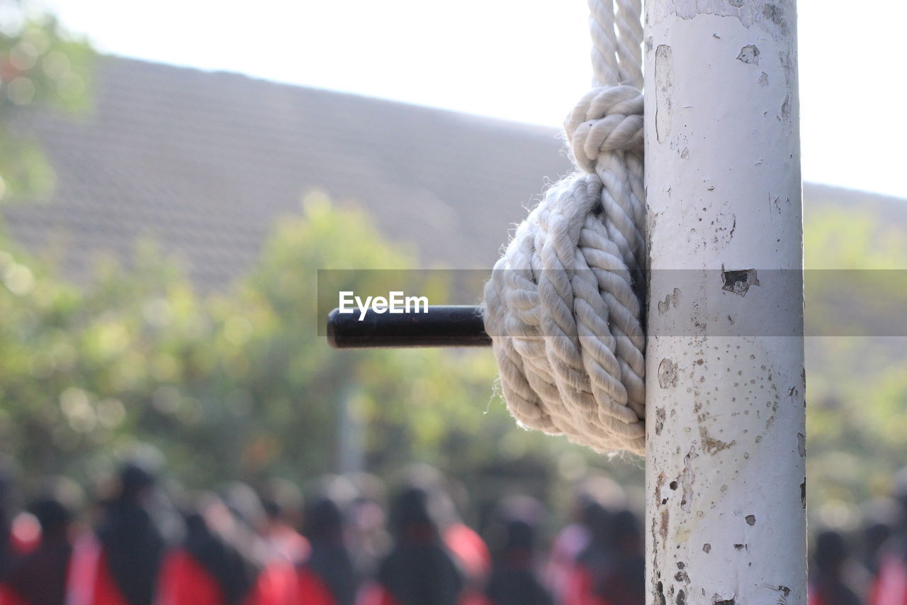 Close-up of rope tied to metal pole