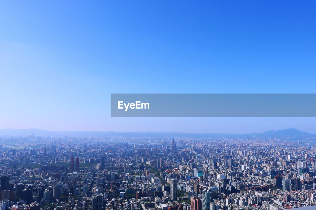 High angle view of illuminated cityscape against sky