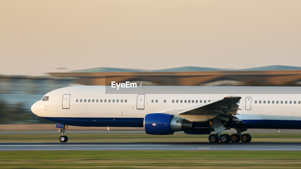 Airplane on airport runway against clear sky