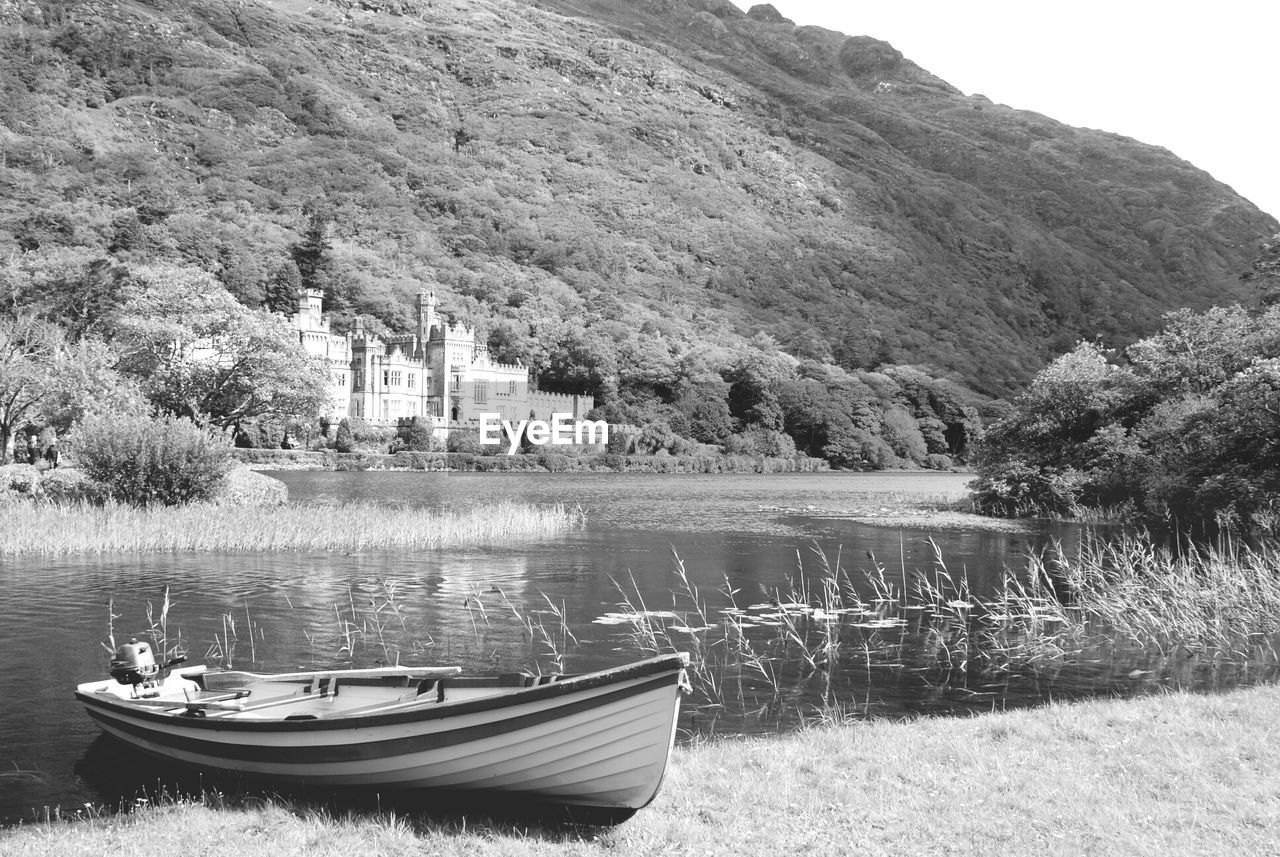 Boat in countryside lake against lush foliage