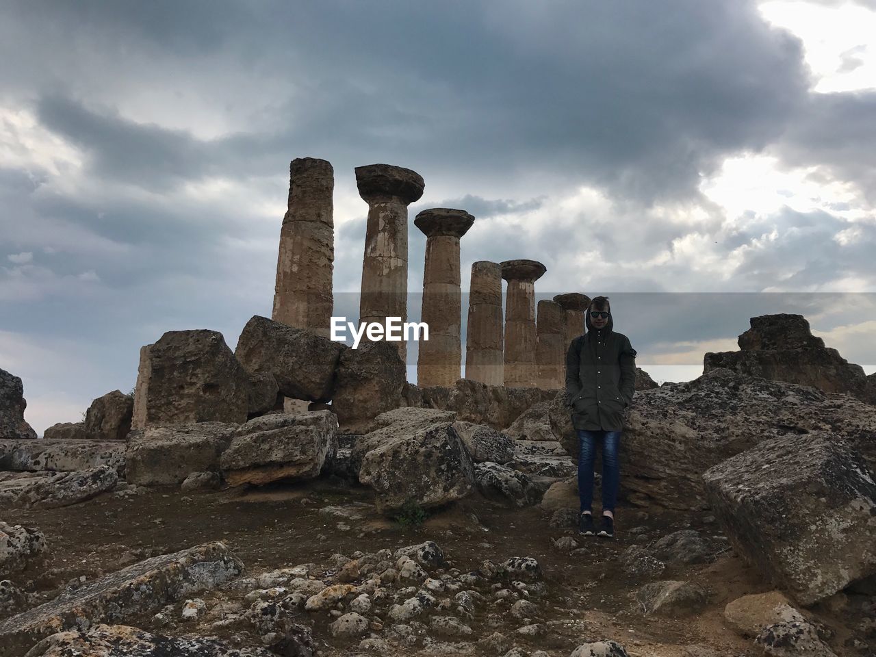 Full length of man standing at valle dei templi against cloudy sky