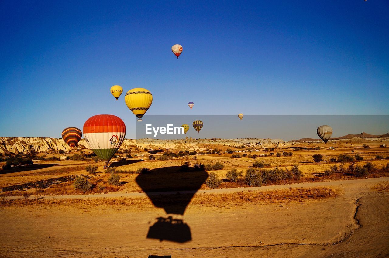 HOT AIR BALLOON FLYING OVER LAND