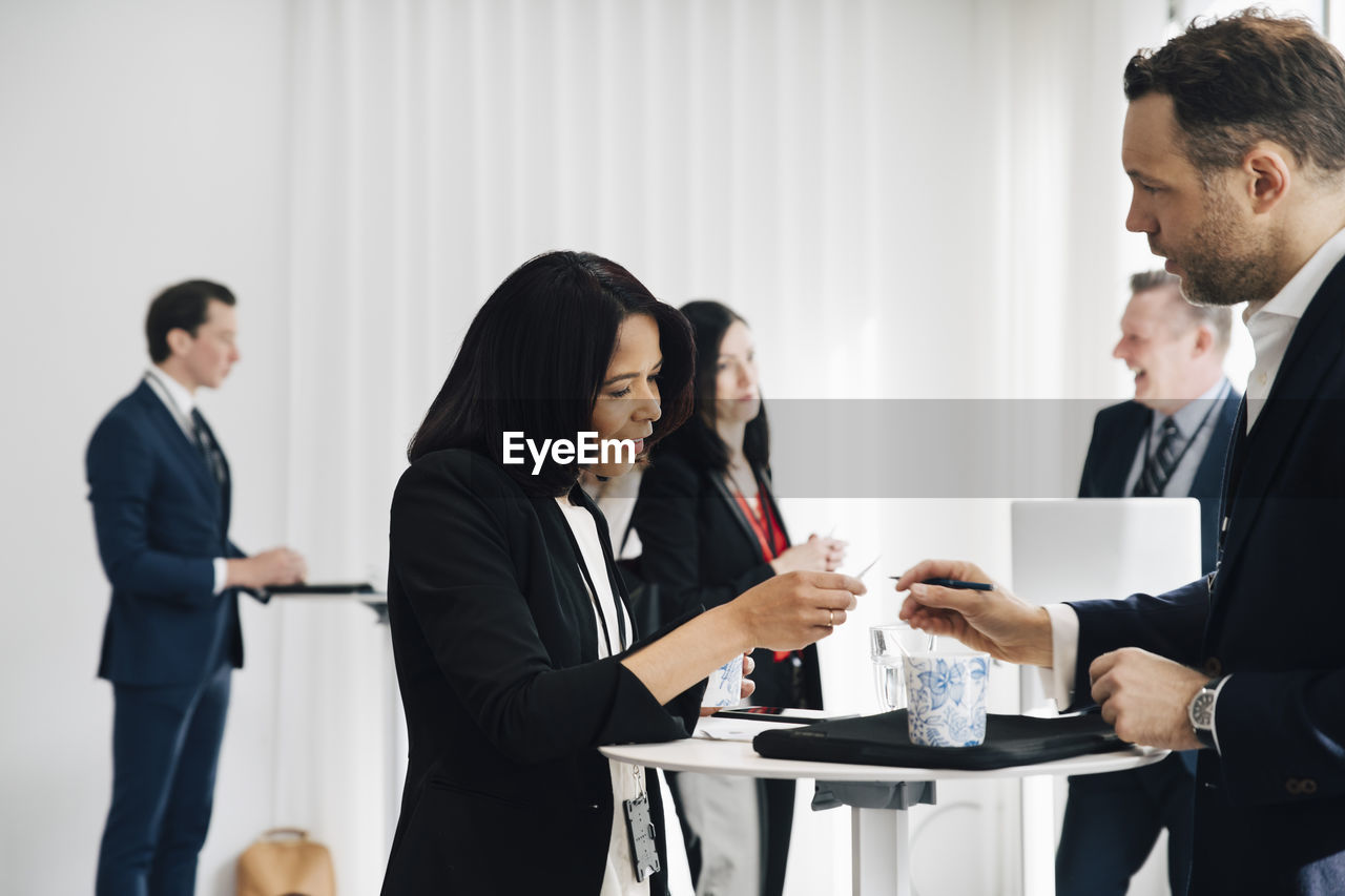 Female and male entrepreneur discussing at workplace