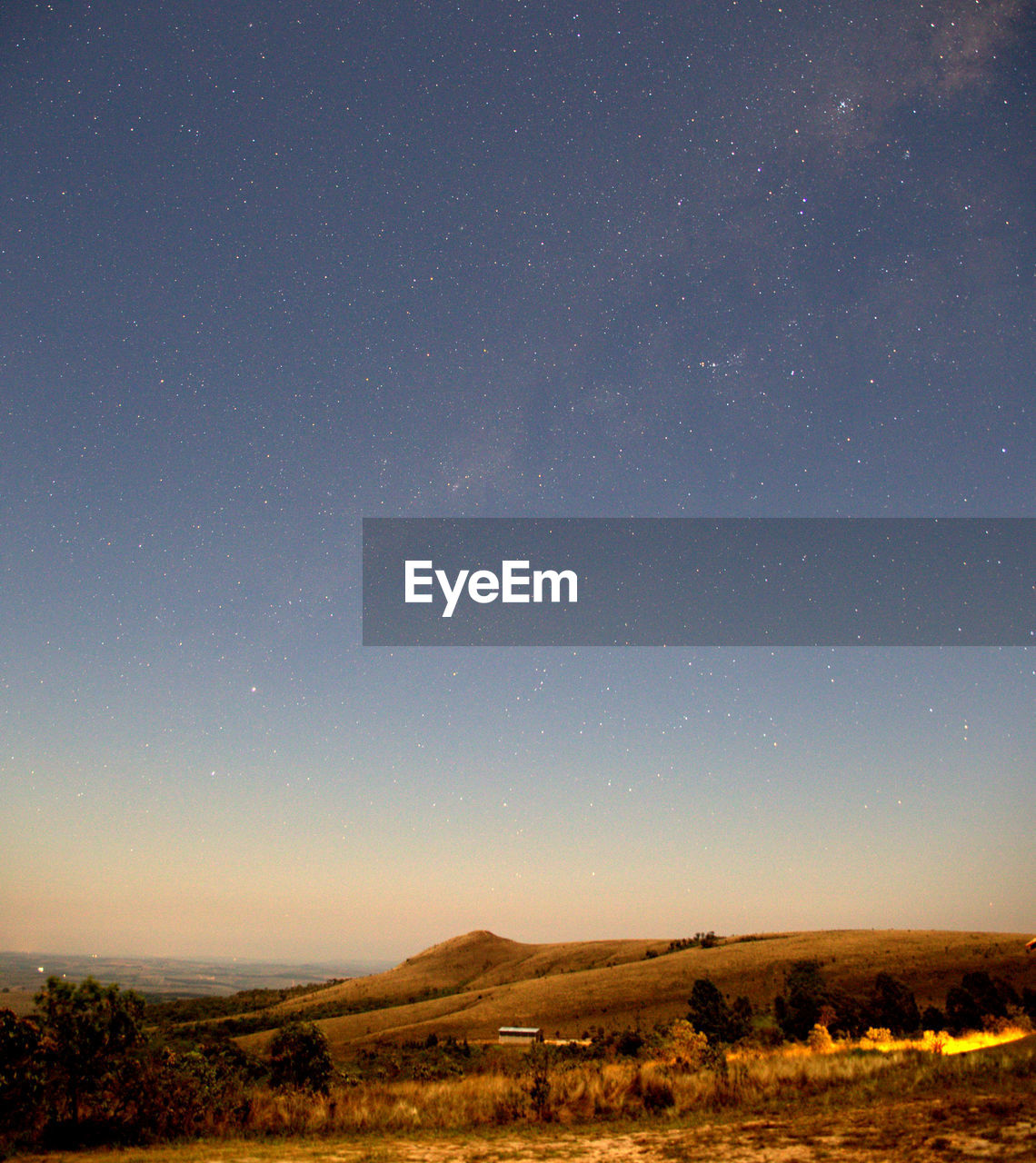 SCENIC VIEW OF LANDSCAPE AGAINST STAR FIELD