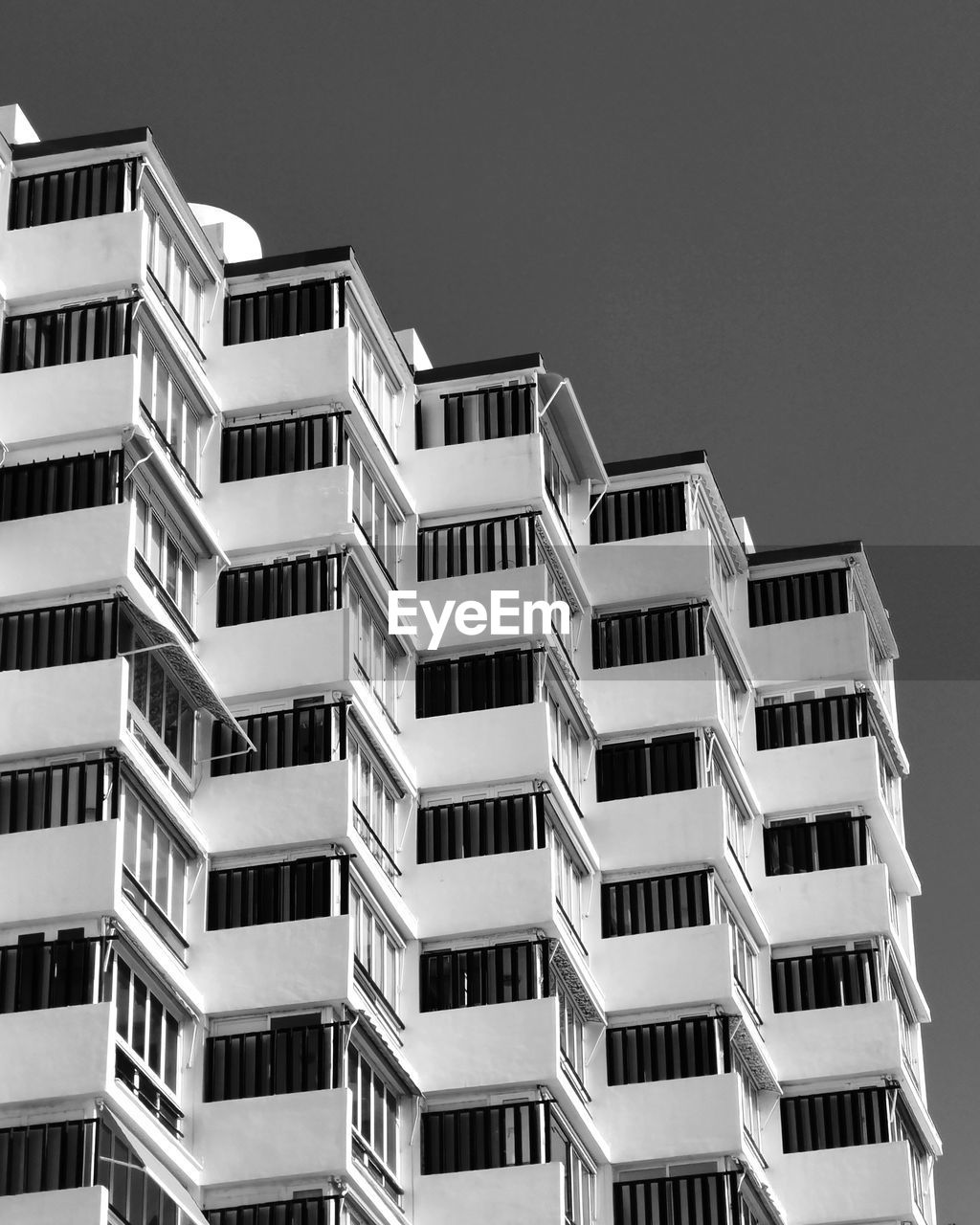 Low angle view of pattern building facade against clear sky