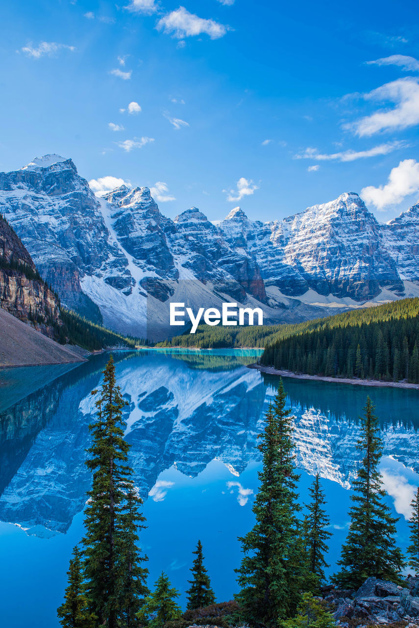 Scenic view of lake and snowcapped mountains against sky during winter