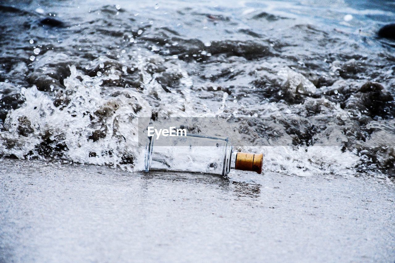 Aerial view of water bottle on sea shore