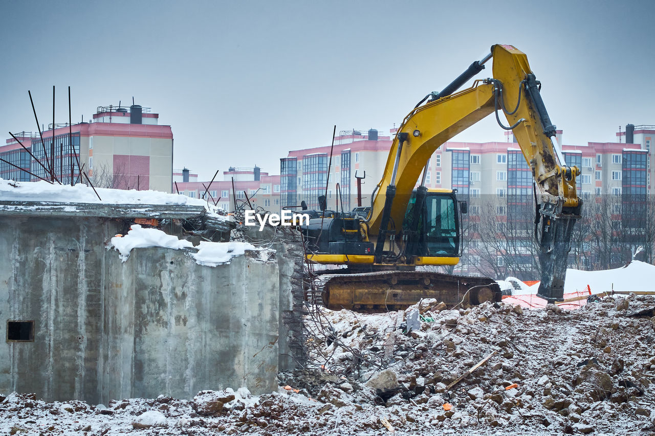 Demolition of old concrete building. hydrohammer crushes building