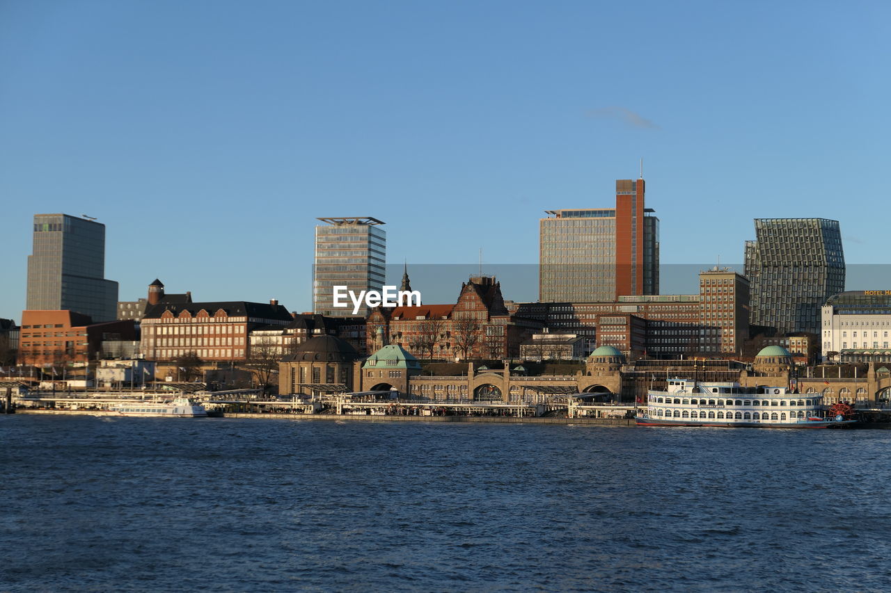 SEA BY BUILDINGS AGAINST CLEAR SKY