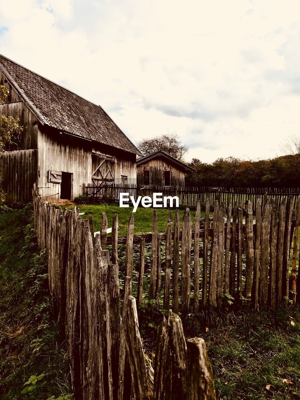 Wooden fence on field against sky