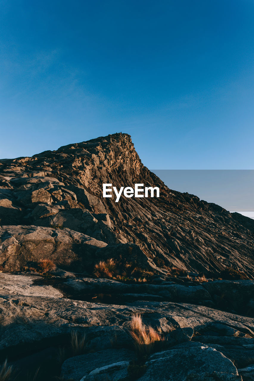 SCENIC VIEW OF MOUNTAINS AGAINST BLUE SKY