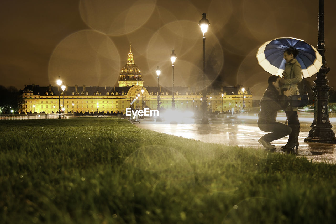 Man and woman romancing on road at night