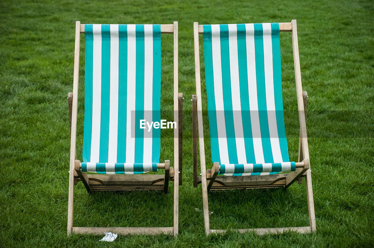 Two deck chairs on grassy area