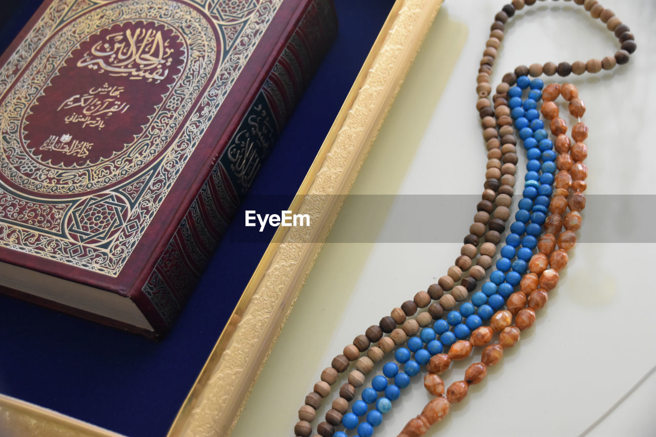 jewelry, necklace, no people, wealth, art, indoors, luxury, jewellery, ornate, close-up, fashion, craft, bead, group of objects, blue, gold, elegance, studio shot, history, bracelet, pattern, still life