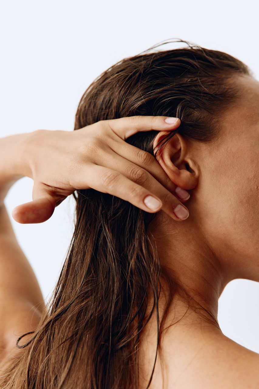 close-up of young woman looking away against white background