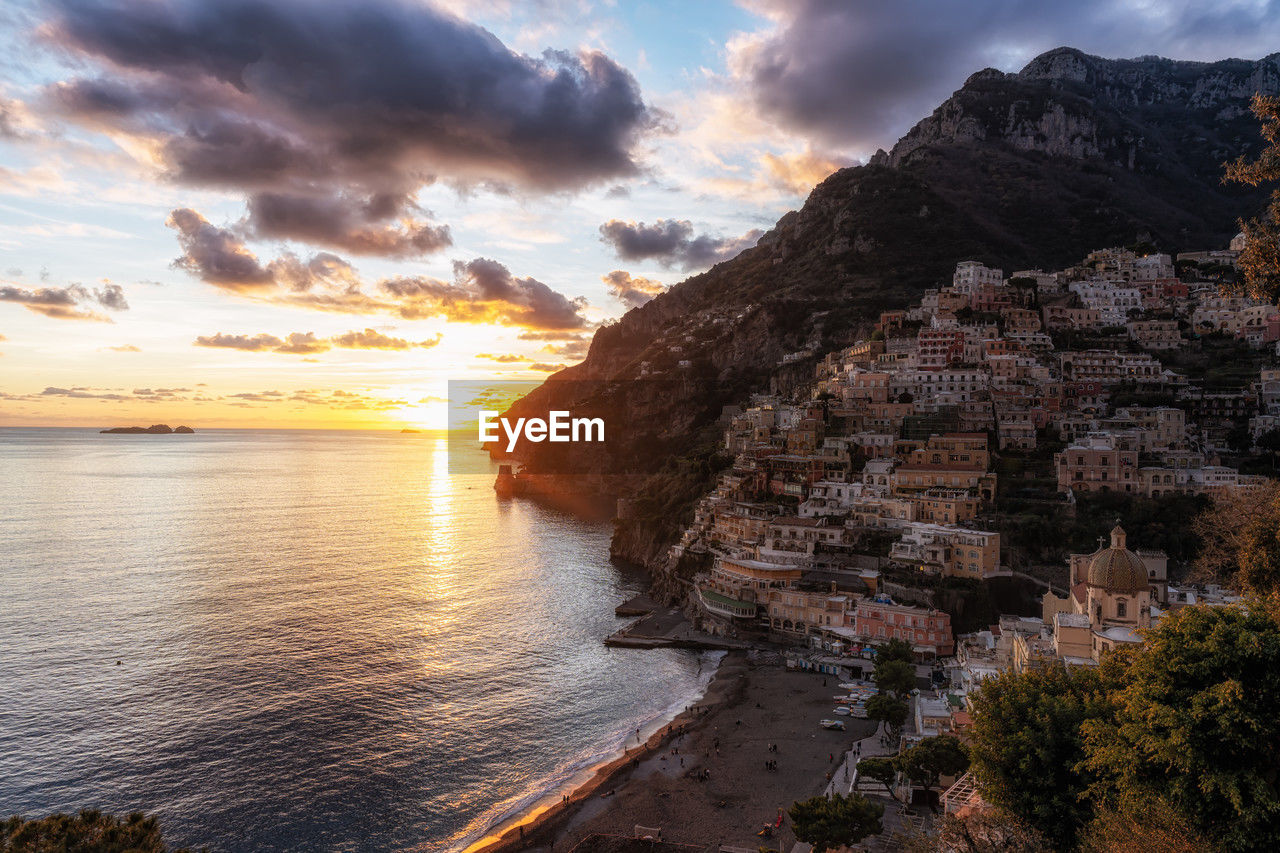 sky, water, sunset, sea, cloud, coast, land, scenics - nature, nature, beauty in nature, beach, environment, travel destinations, landscape, travel, rock, mountain, architecture, sun, dramatic sky, coastline, shore, cliff, dusk, tourism, tranquility, sunlight, seascape, outdoors, no people, city, evening, holiday, vacation, trip, reflection, horizon, tranquil scene, bay, panoramic, ocean, summer, terrain, tree, plant, multi colored, horizon over water, idyllic, cloudscape, building