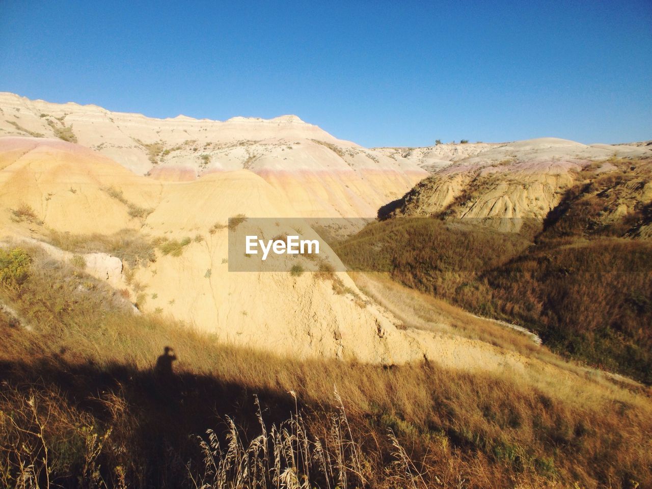 Scenic view of badlands national park against clear blue sky