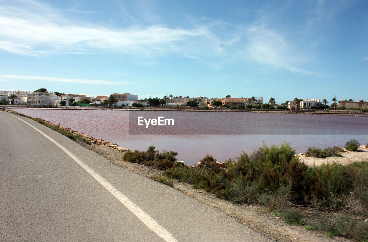 sky, water, shore, city, nature, road, architecture, transportation, coast, cloud, sea, horizon, land, environment, travel, landscape, travel destinations, beach, built structure, street, no people, scenics - nature, blue, tourism, building, building exterior, plant, day, beauty in nature, outdoors, tranquility, coastline, symbol, urban skyline, trip, holiday, vacation, tranquil scene, cityscape, sunny, tree