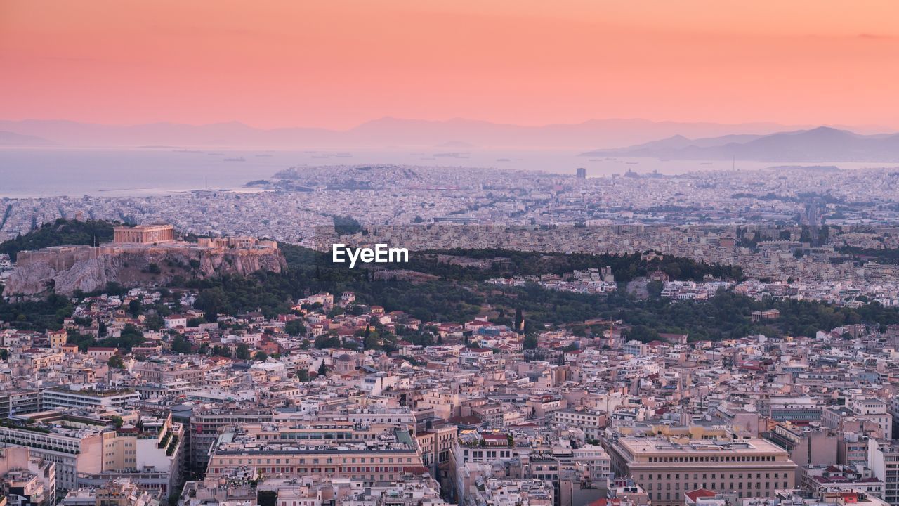 Aerial view of cityscape against sky during sunset