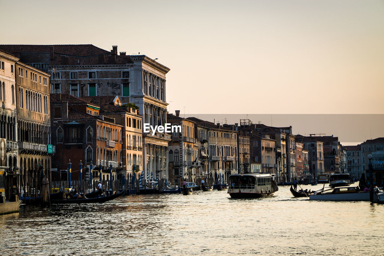 Boats in canal with buildings in background