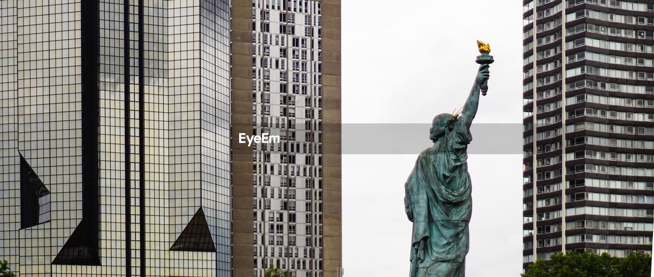 LOW ANGLE VIEW OF STATUE IN CITY