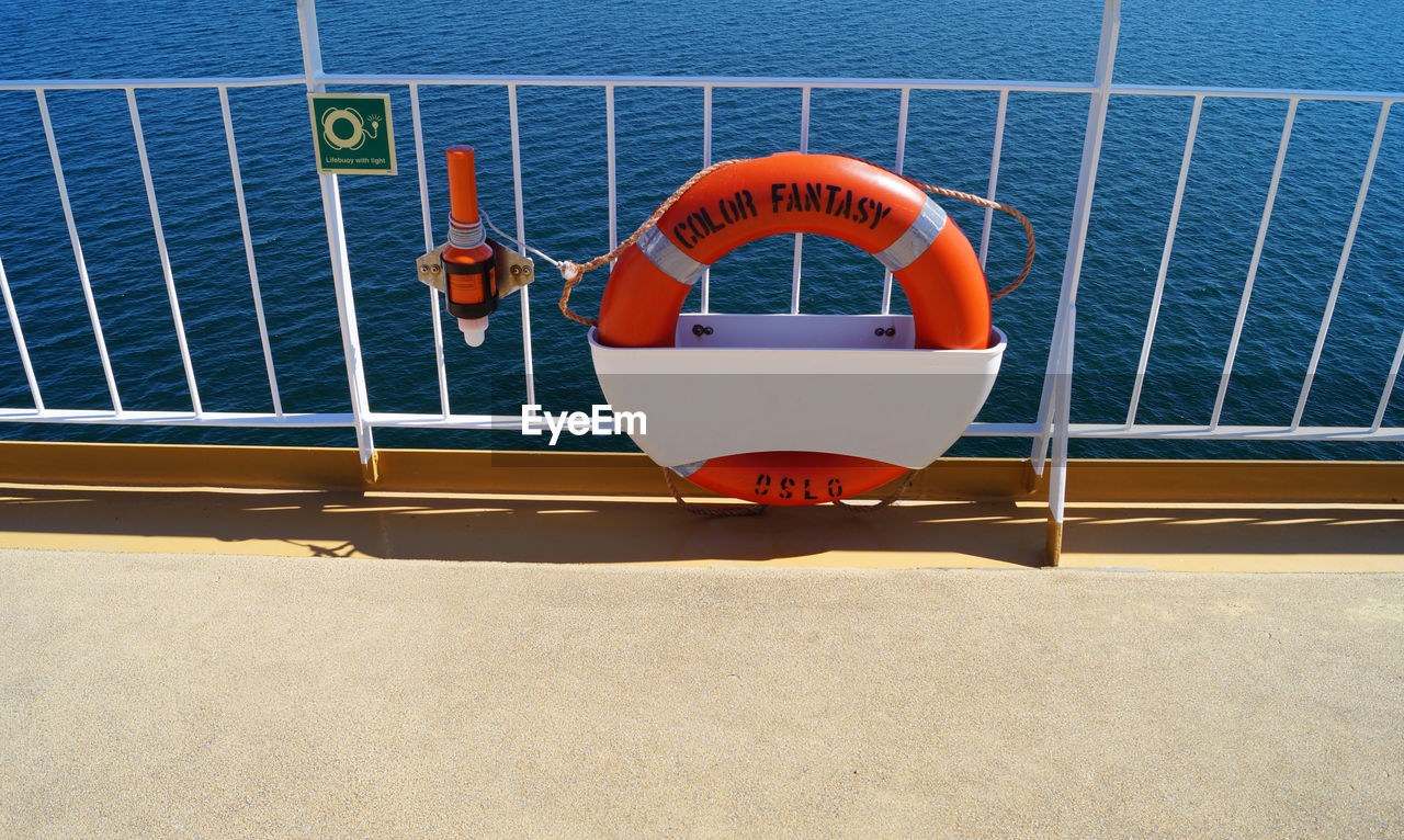 VIEW OF BOAT IN SEA AGAINST RAILING