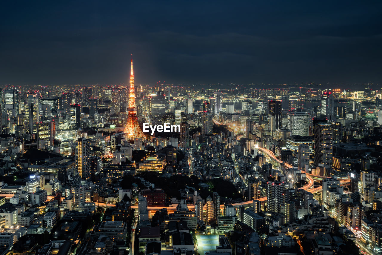 High angle view of city lit up at night