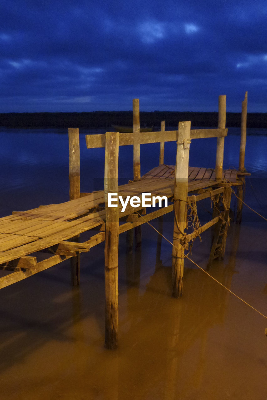 PIER ON BEACH AGAINST SKY