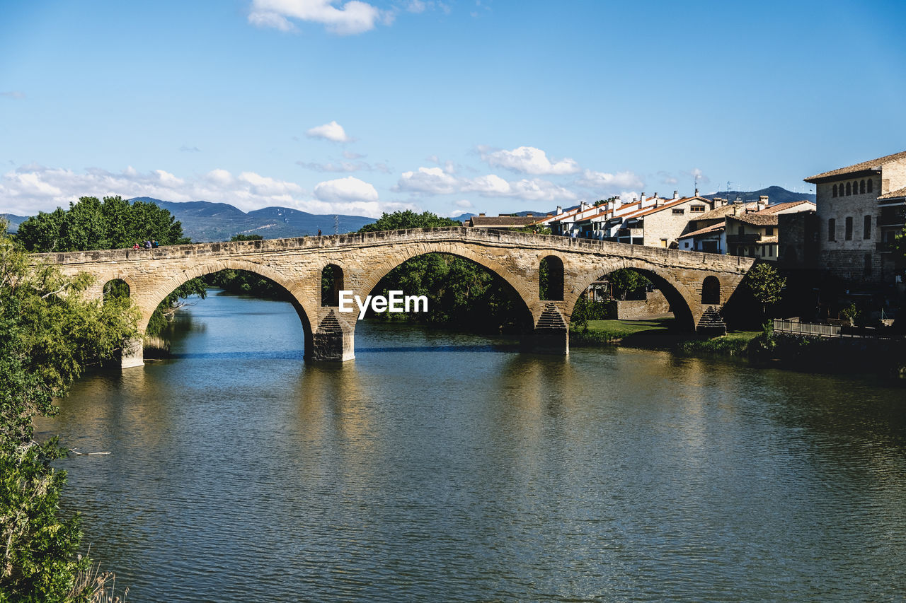 ARCH BRIDGE OVER RIVER AGAINST SKY