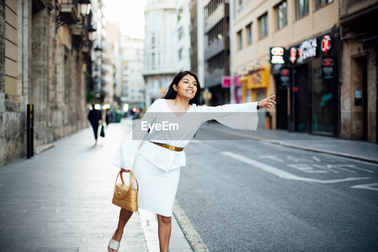 Full length of woman on street in city