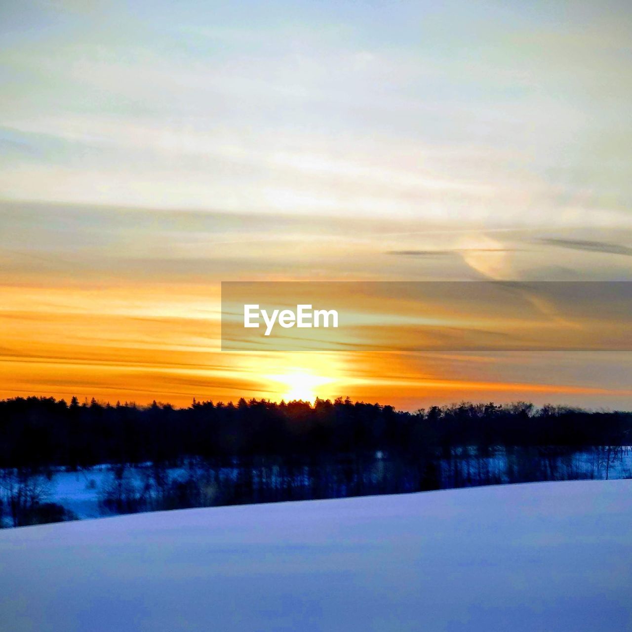 SCENIC VIEW OF SNOW COVERED LANDSCAPE DURING SUNSET