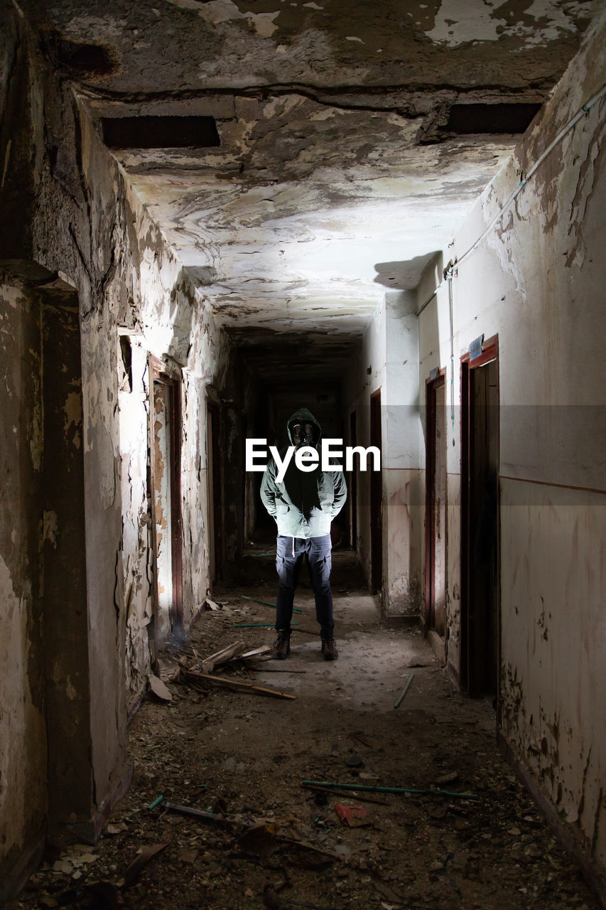 Man standing in abandoned building