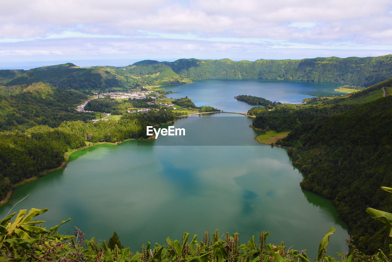 Scenic view of lake and mountains against sky