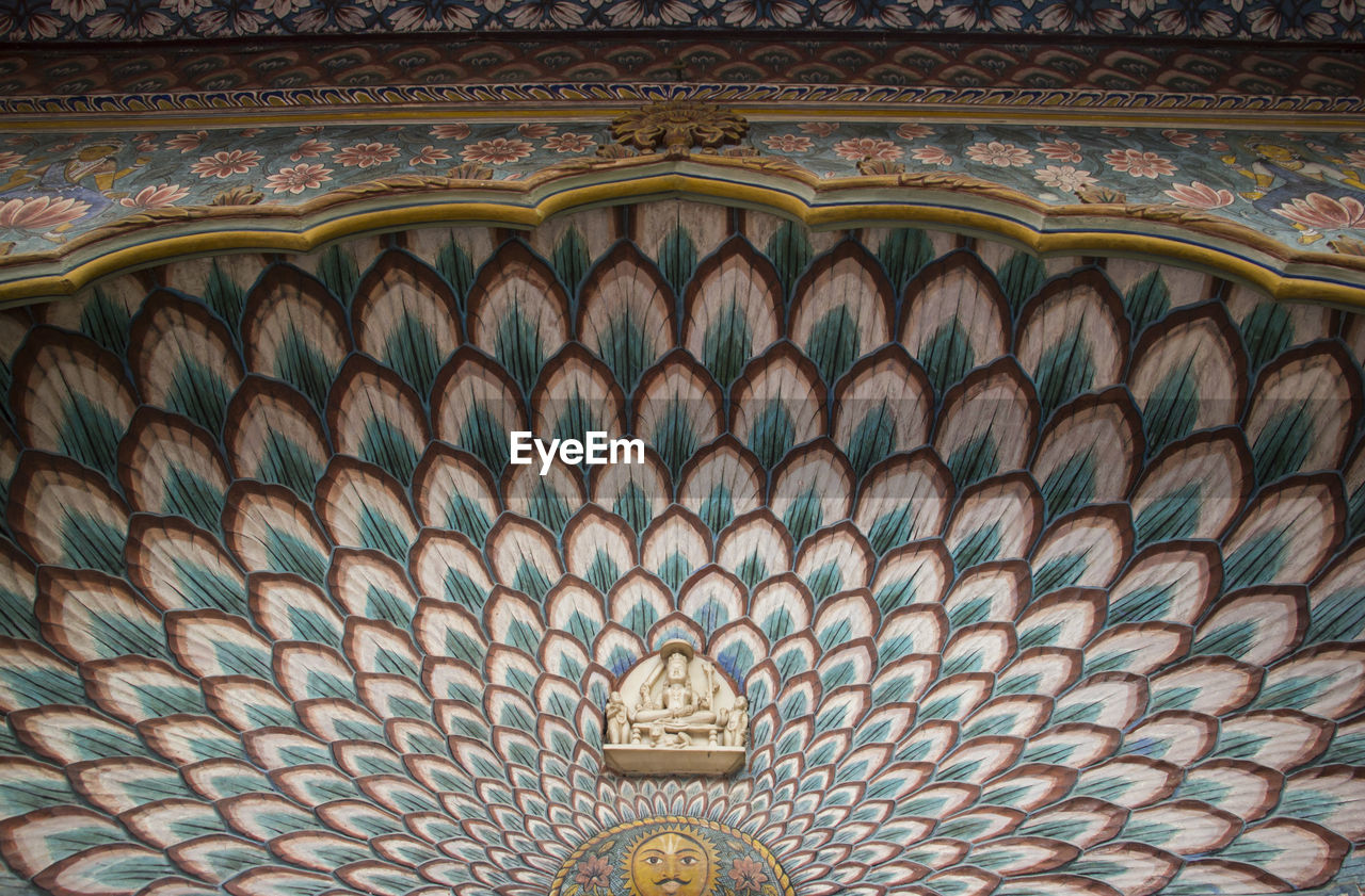 Low angle view of ornate ceiling in temple