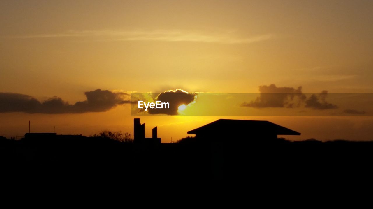 SILHOUETTE OF BUILDING AT SUNSET