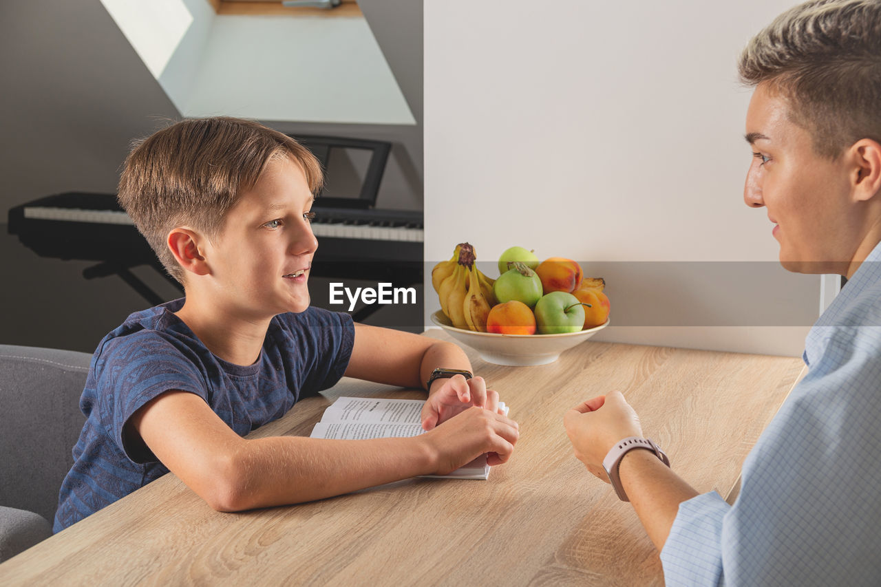 Man and son on table