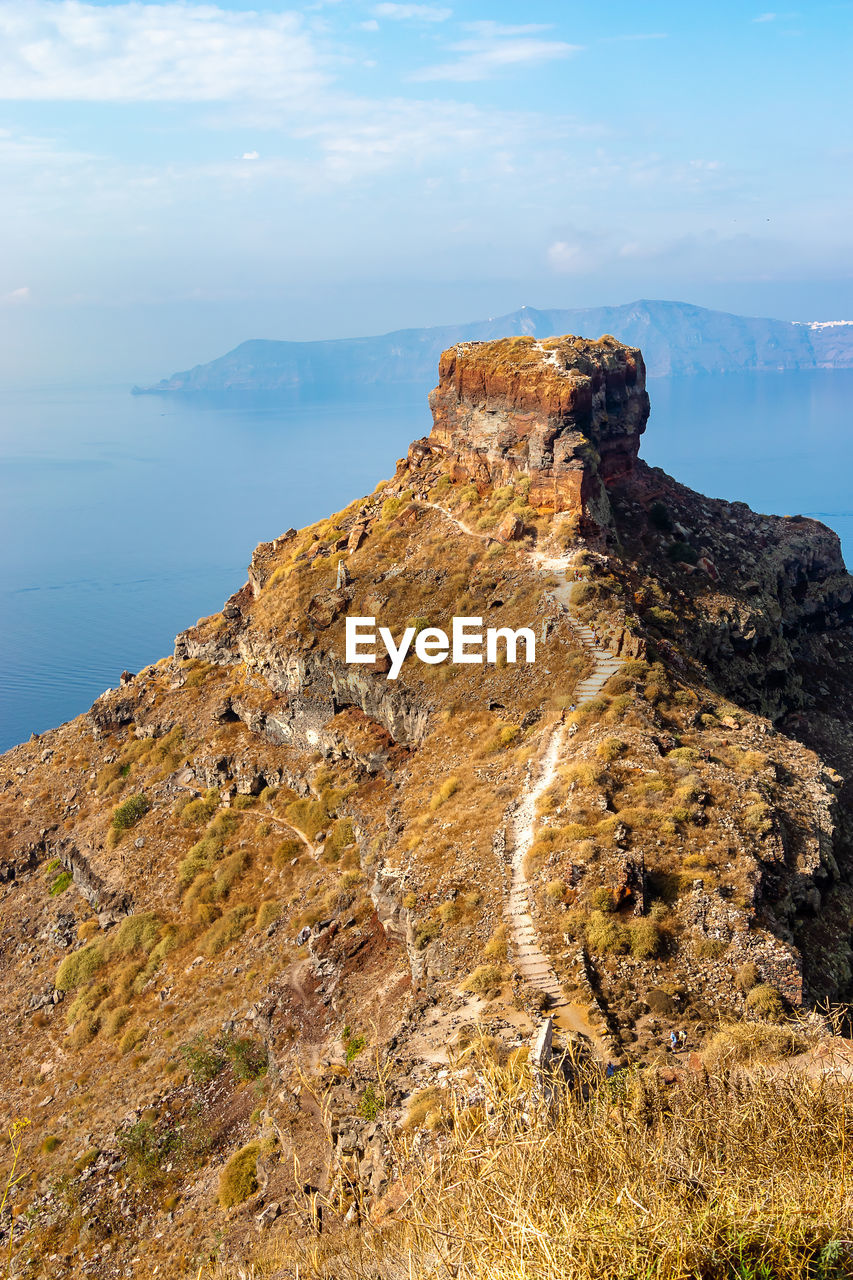 Rock formations on shore against sky