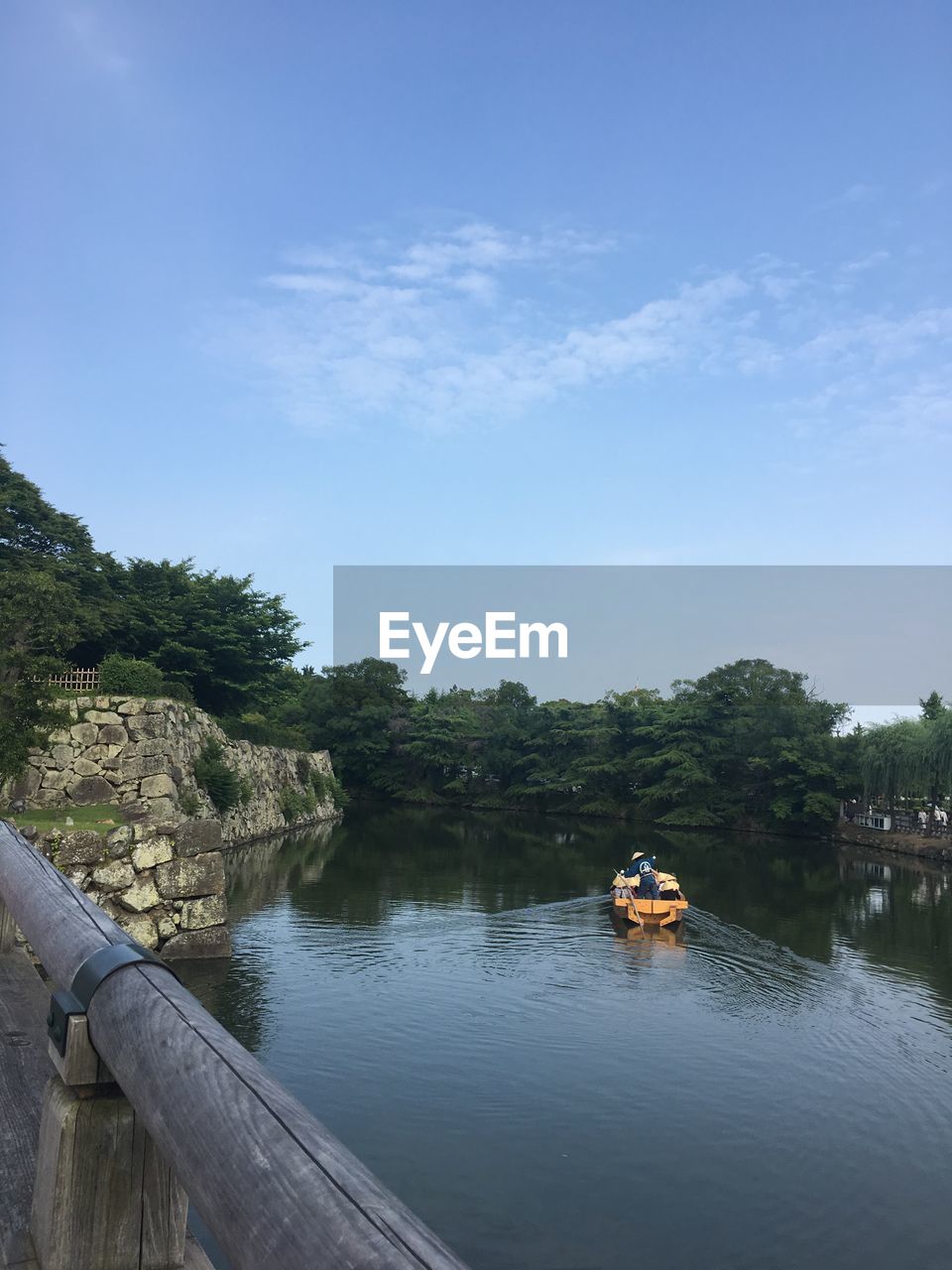 BOAT ON RIVER AGAINST SKY