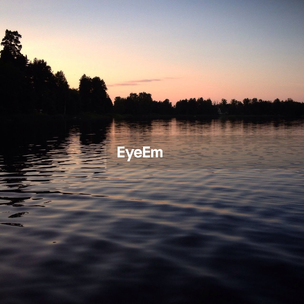 SCENIC VIEW OF LAKE AT SUNSET